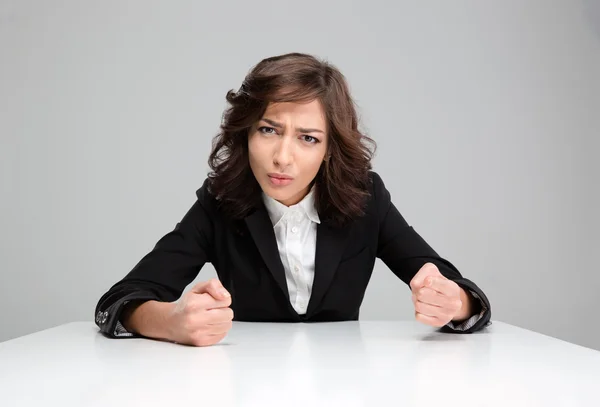 Mad aggressive young woman sitting and pointing on you — Stock Photo, Image