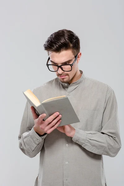 Smart handsome young man reading book — Stock Photo, Image