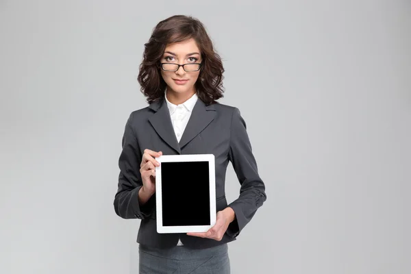 Confident curly woman showing blank tablet computer screen Stock Picture