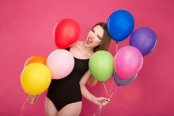 Crazy screaming young woman pozing with colorful balloons — Stok fotoğraf
