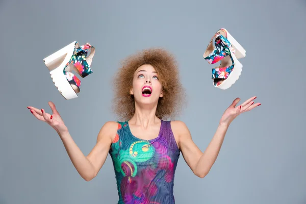 Excited carefree young woman amazed about flying shoes — Stock Photo, Image