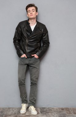 Full length portrait of a casual man in leather jacket 