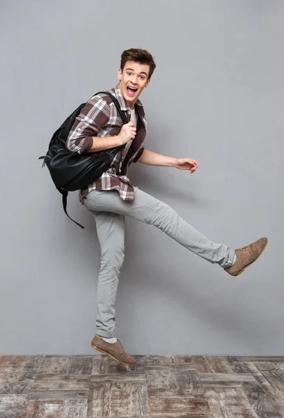 Funny cheerful male student jumping — Stok fotoğraf