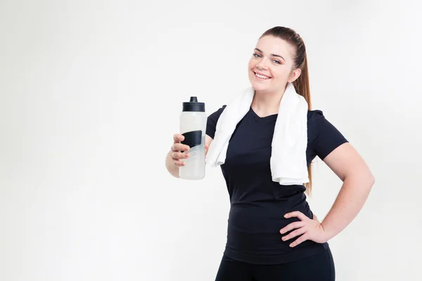 Smiling thick woman in sportswear holding shaker — Stock Photo, Image