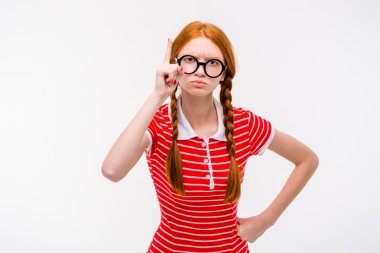 Strict young woman with two braids pointing up 