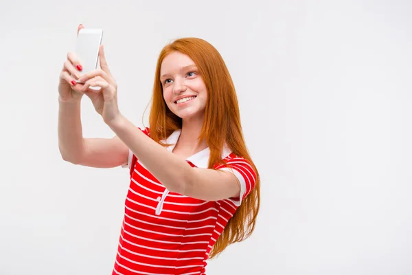 Portrait of cheerful young woman making selfie using cellphone — Stok fotoğraf