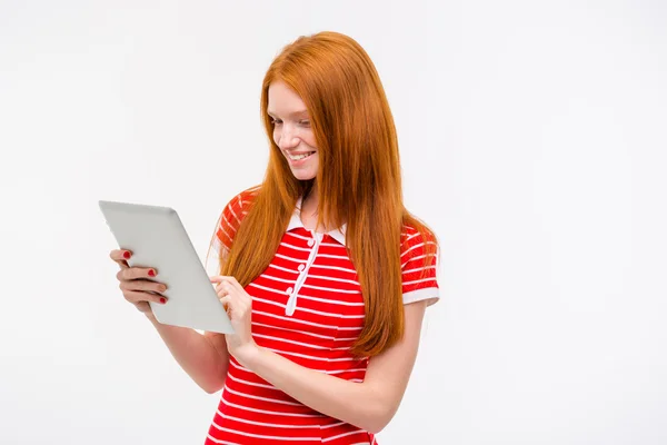 Happy smiling redhead girl using tablet — Stok fotoğraf