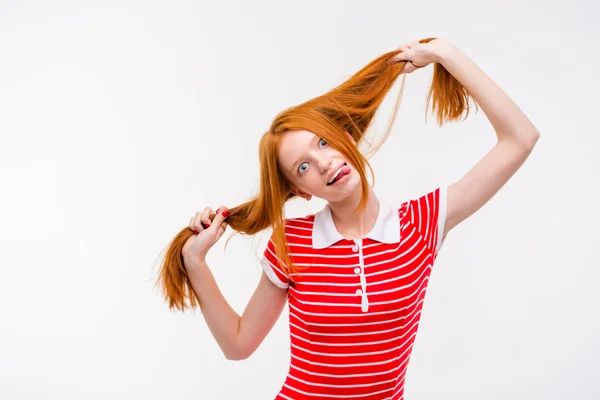 Amusing redhead young woman showing tongue and having fun — Zdjęcie stockowe