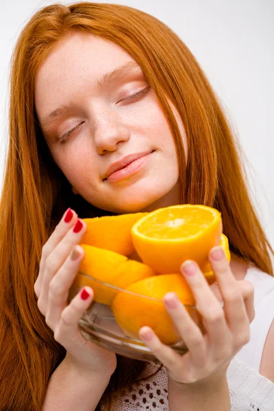 Closeup portrait of sensual tender young woman holding oranges — Stock Photo, Image