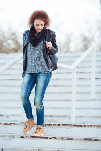 Vrouw met krullend haar lopen van trap buiten — Stockfoto