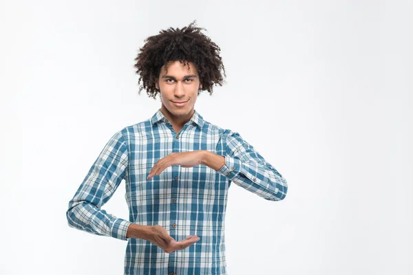 Afro american man holding something invisible — Stock Photo, Image