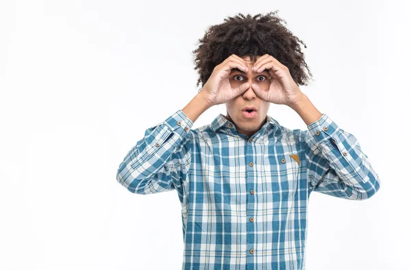 Man with curly hair looking into the distance at camer — Stockfoto