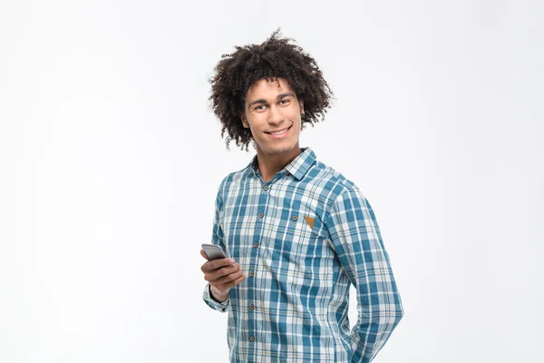 Smiling afro american man holding smartphone — Stock Fotó