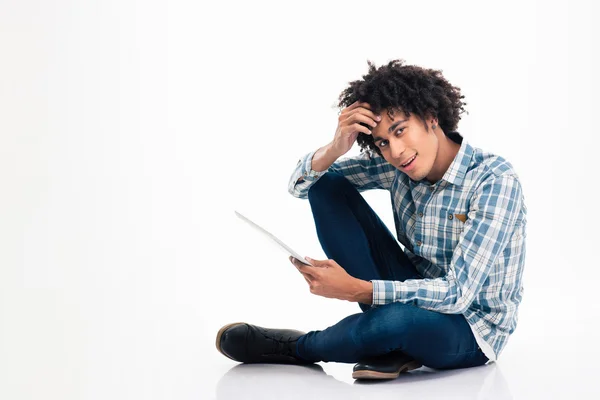 Afro american man sitting on the floor with laptop computer — Stockfoto