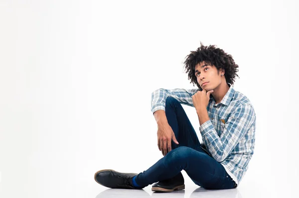 Pensive afro american man sitting on the floor — Zdjęcie stockowe