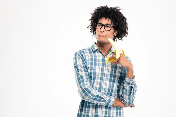 Thoughtful afro american man holding banana — Stock Fotó