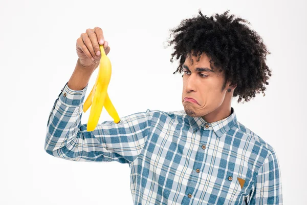 Sad afro american man holding banana skin — Zdjęcie stockowe