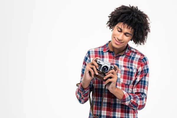 Afro american man making photo on retro camera — Stockfoto