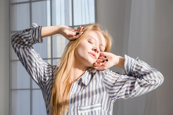 Young sleepy woman stretching with closed eyes — Stock Fotó