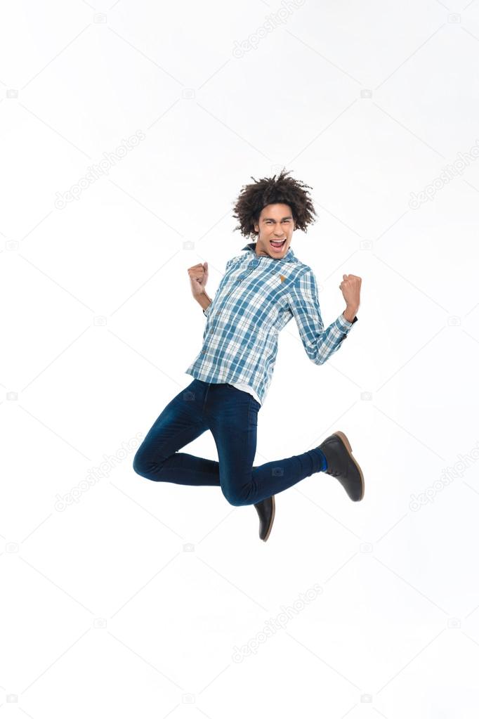 Cheerful afro american man jumping 