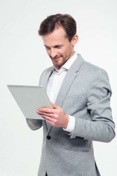 Happy businessman using tablet computer