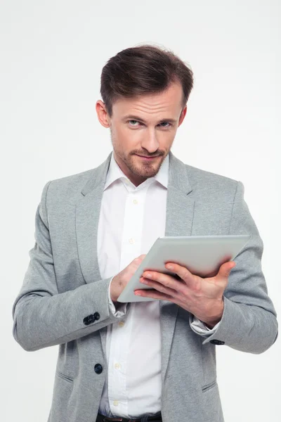 Businessman using tablet computer and looking at camera — Stock Photo, Image