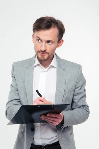 Businessman writing notes in clipboard — Stock Photo, Image
