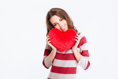 Smiling pretty woman holding red heart