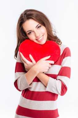 Portrait of a happy woman holding red heart