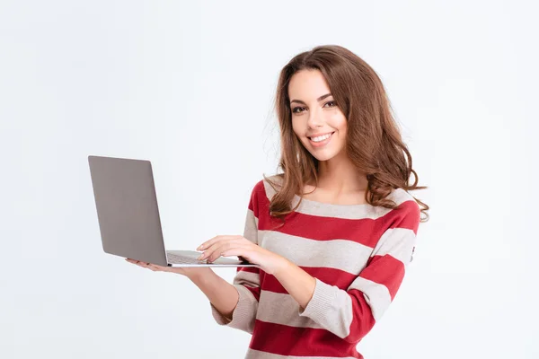 Smiling cute woman using laptop computer — ストック写真