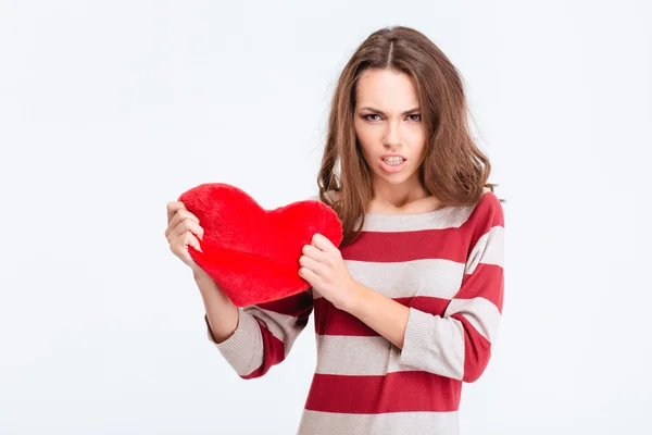 Angry woman holding red heart — Stock Photo, Image