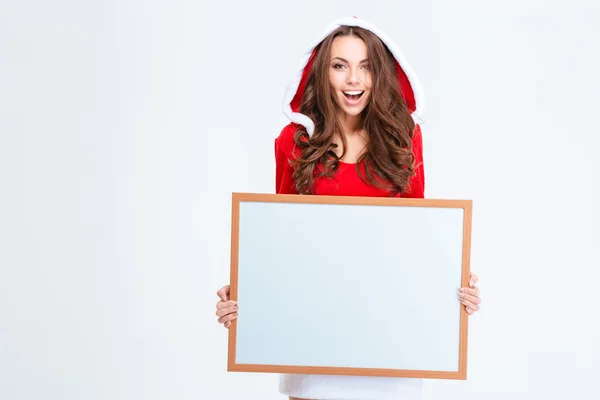 Cheerful woman in santa claus cloth holding blank board — Stock Photo, Image