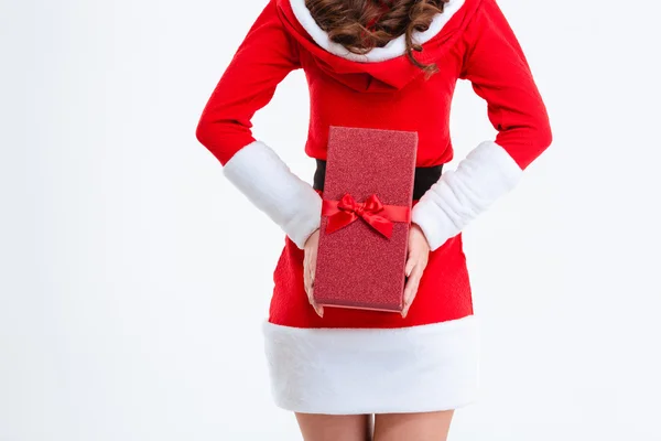 Vista trasera de la mujer sosteniendo el regalo de Navidad detrás de la espalda —  Fotos de Stock