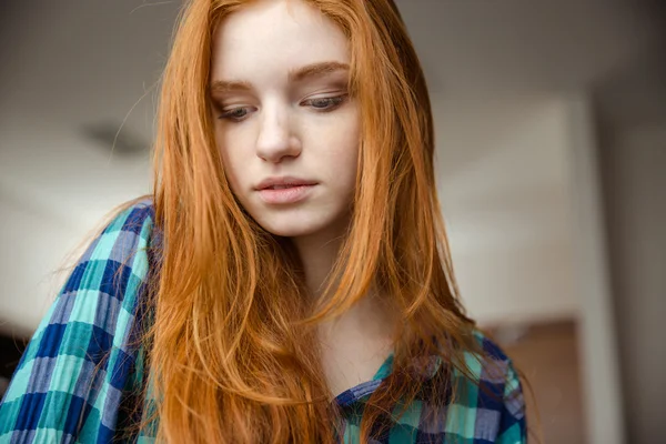 Closeup of shy girl with red hair in checkered shirt — Stock Photo, Image