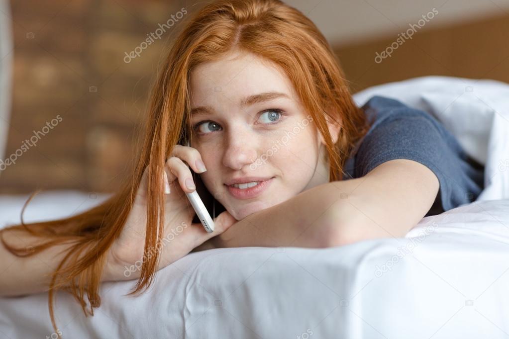 Woman talking on the phone in bed