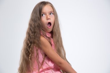 Portrait of shocked little girl looking away clipart