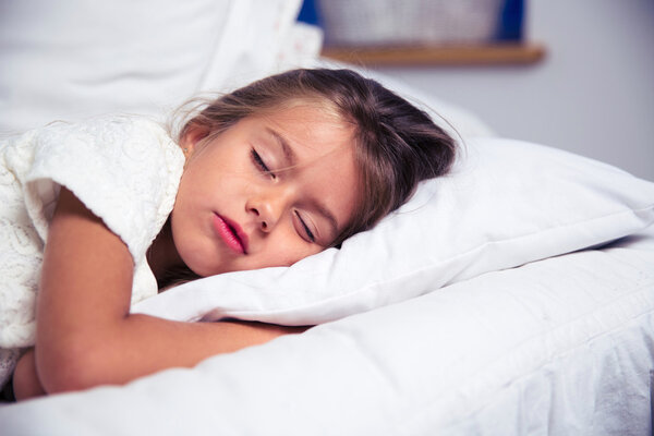 Little girl sleeping in bed 