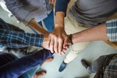 People joining hands together 