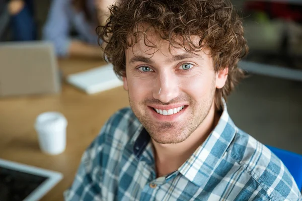 Closeup of happy curly handsome man in checkered shirt — Stock Photo, Image