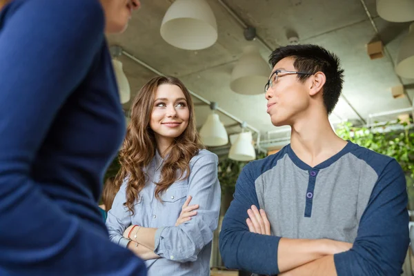 Beautiful woman and young asian man looking on each other — Stock Photo, Image