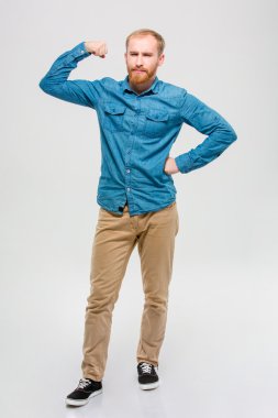 Amusing bearded man showing his muscles 