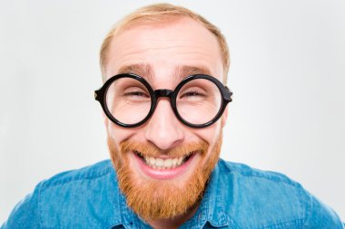 Funny cheerful bearded man in round glasses
