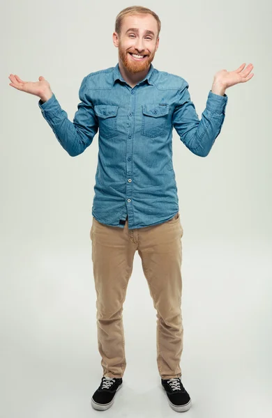 Sorrindo homem casual encolhendo ombros — Fotografia de Stock