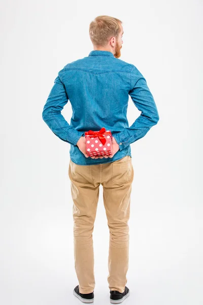 Back view of  man with beard holding red gift — Stock Photo, Image