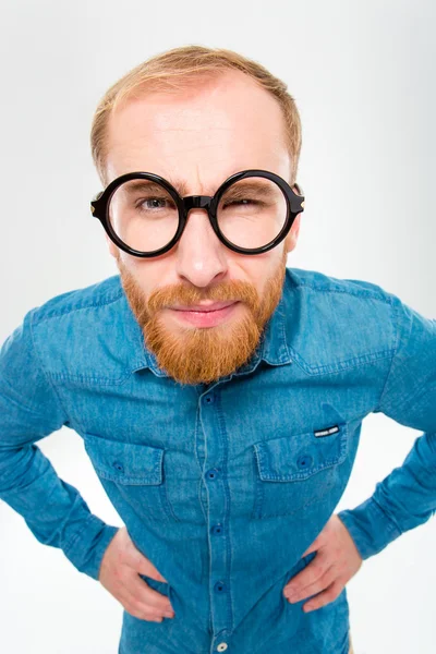 Angry amusing young man with beard in funny round glasses — Zdjęcie stockowe