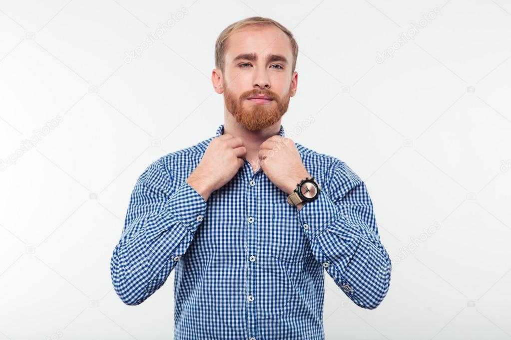 Casual man buttoning his shirt