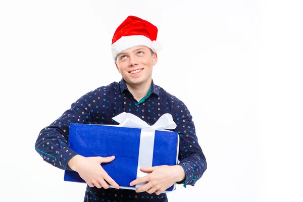 Excited anticipated male in santa claus hat holding gift — Stock Photo, Image