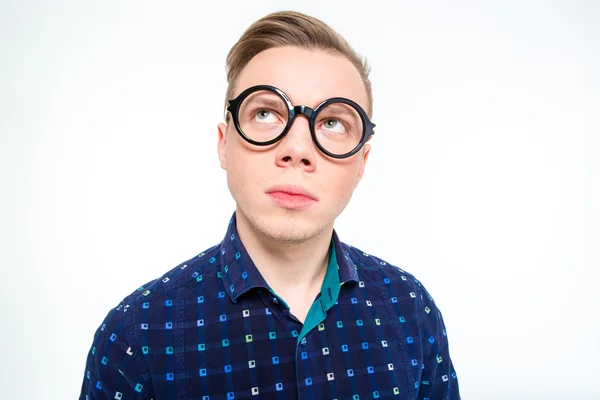 Funny thoughtful male in round glasses looking up and thinking — Stock Fotó