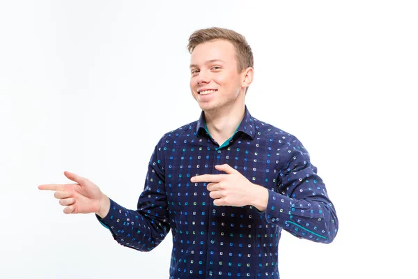 Happy smiling young man pointing away with both hands — Stock Photo, Image