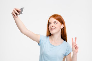 Redhead woman making selfie photo